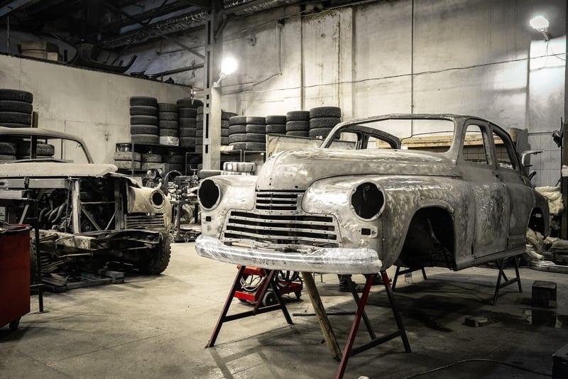 An old car in a restoration shop