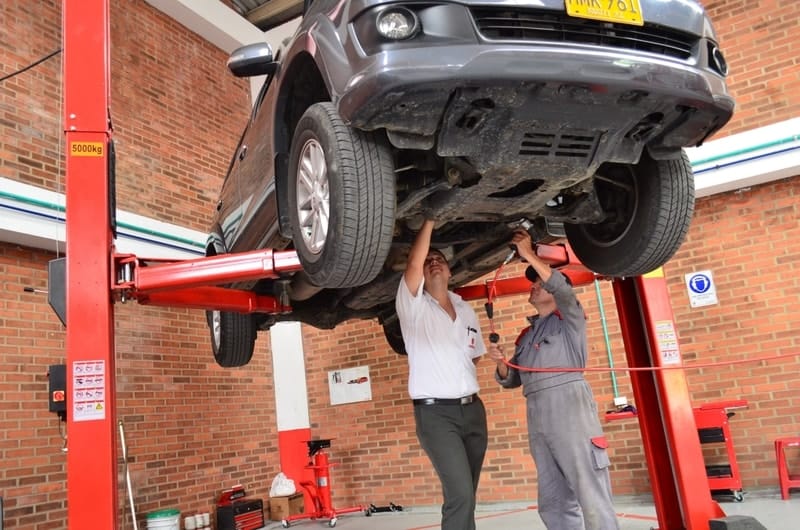 mechanics-repairing-a-raised-car