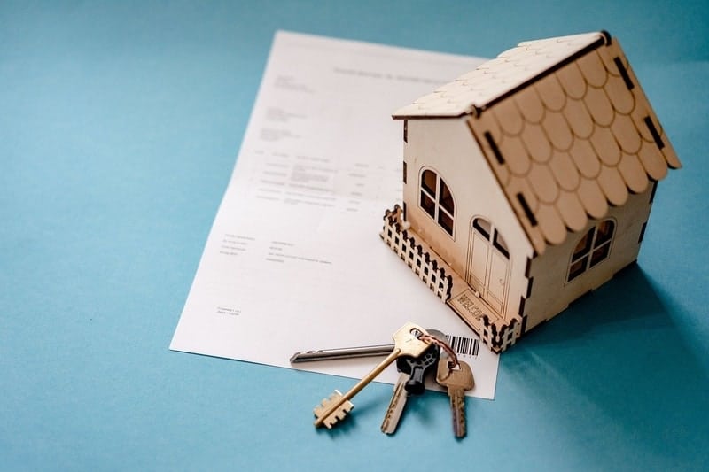 Loan-Application-Documents-Keys-And-Wooden-House