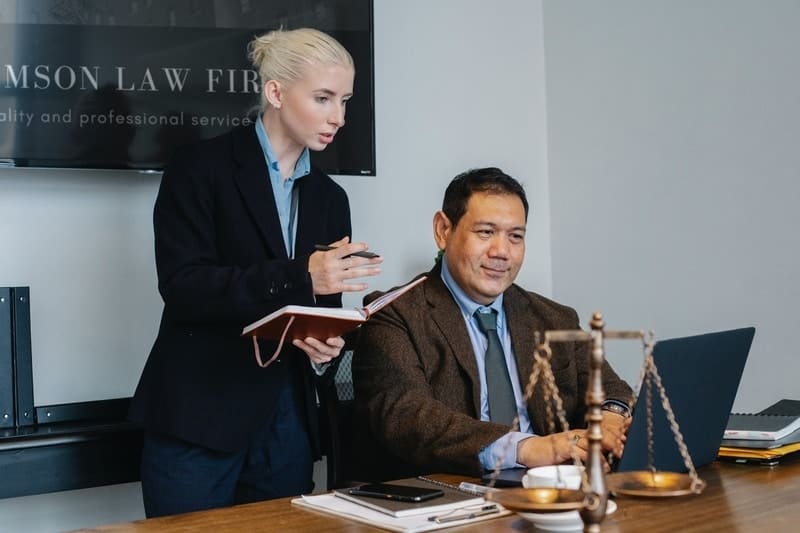 Female-And-Male-Attorneys-Working-On-A-Laptop